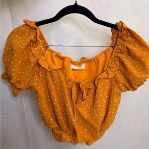 Mustard yellow women’s off the shoulder crop top with starry print